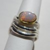 Gold ring with opal with silver rings either side